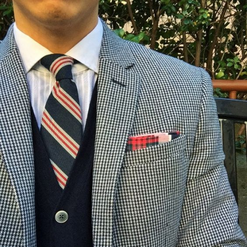 What are you wearing?  (around your neck-striped necktie) phrase image